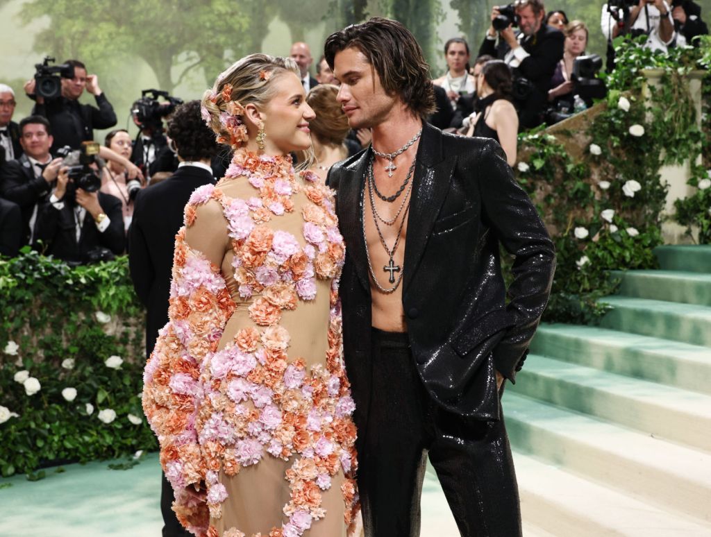 Kelsea Ballerini in a peach dress and Chase Stokes in black attend The 2024 Met Gala Celebrating "Sleeping Beauties: Reawakening Fashion" at The Metropolitan Museum of Art on May 06, 2024 in New York City.