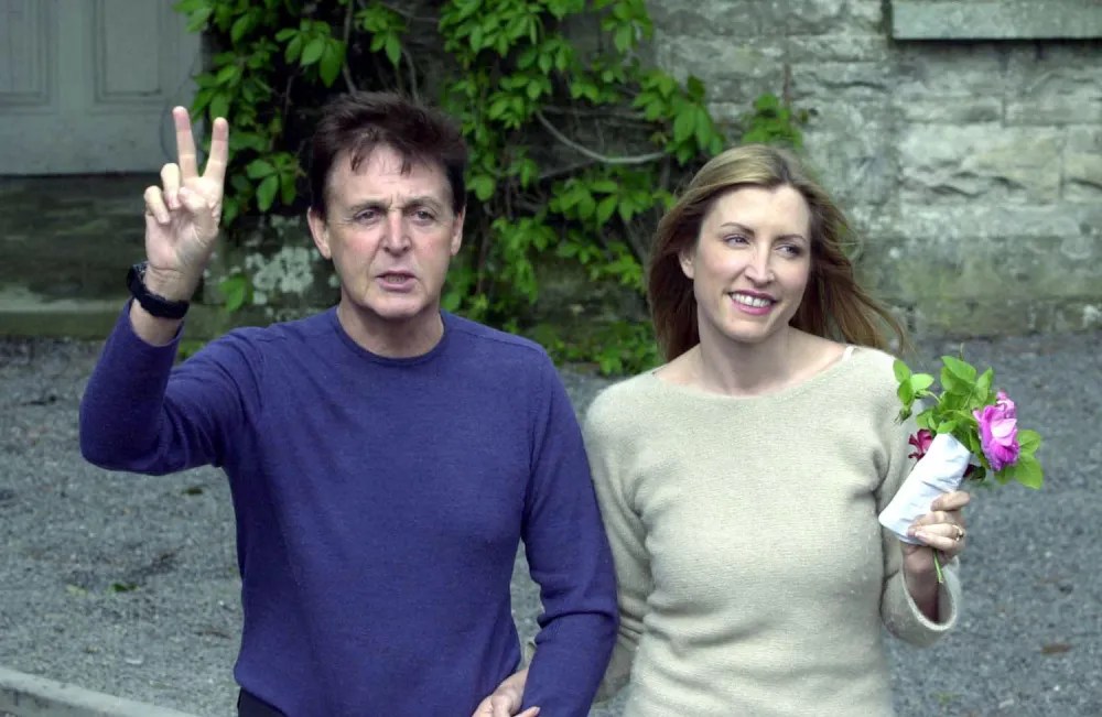 Sir Paul McCartney and his fiance model Heather Mills signals to the news media at Castle Leslie June 10, 2002 in Glaslough Village, County Monaghan, Ireland. The pair will be married on the castle grounds June 11, 2002.